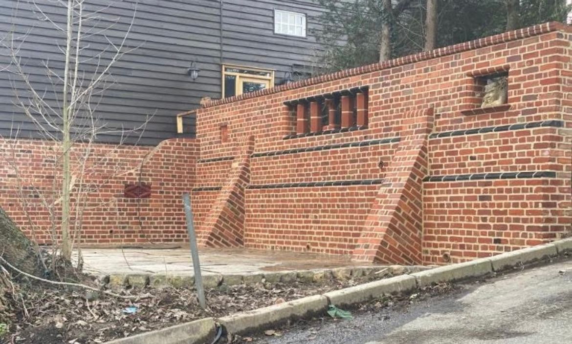 Heritage boundary wall with black diaper brick banding